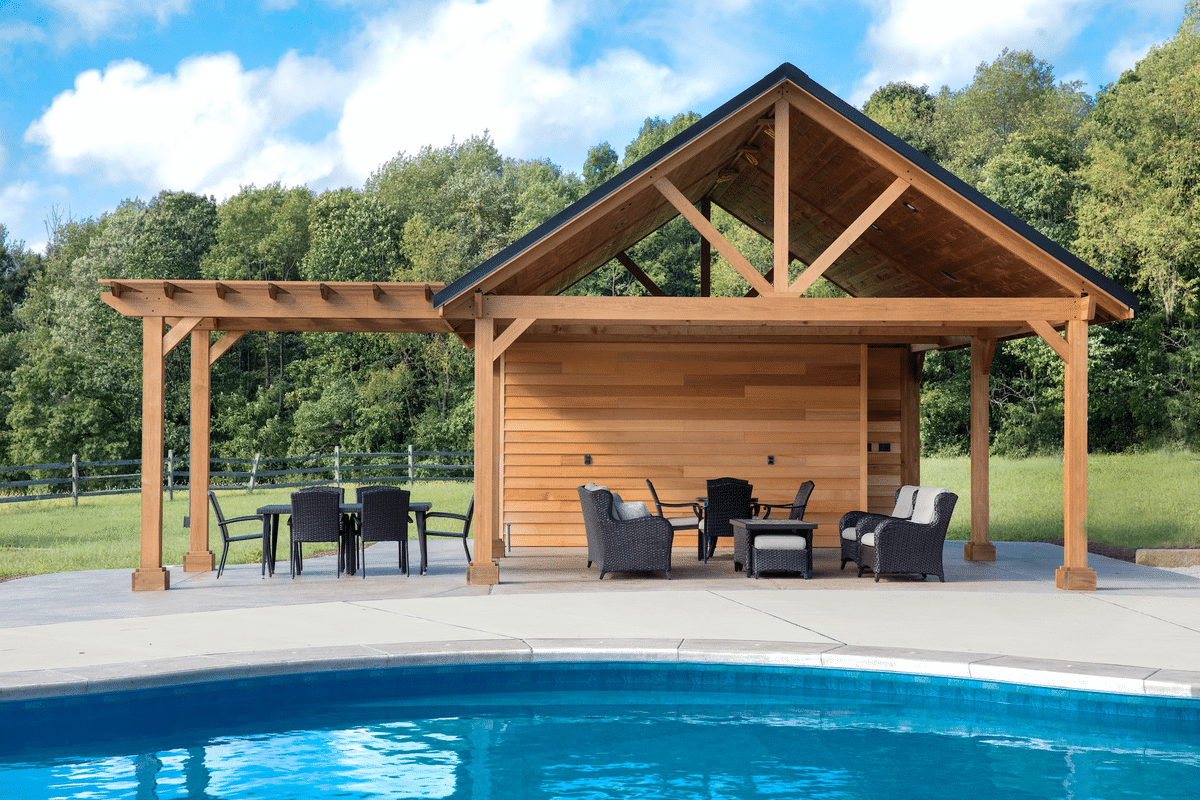 roofed patio with sofas and chairs beside pool