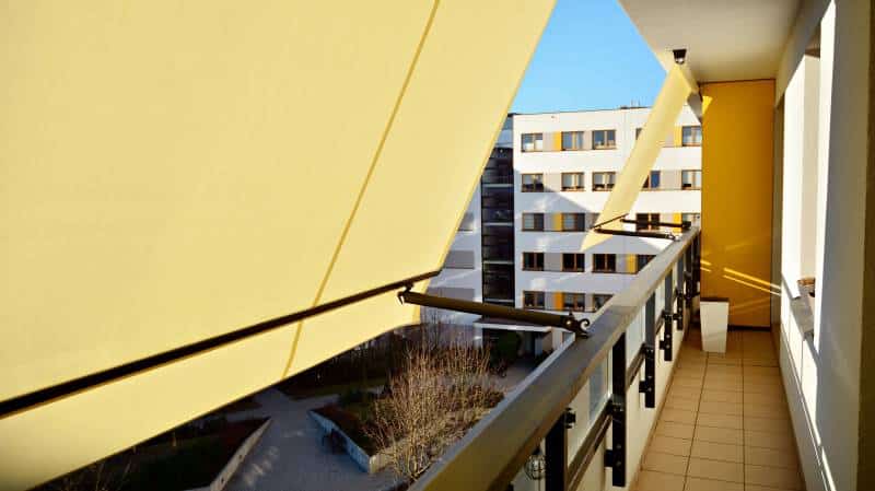 Balcony with awning opened, covered by sun-shield
