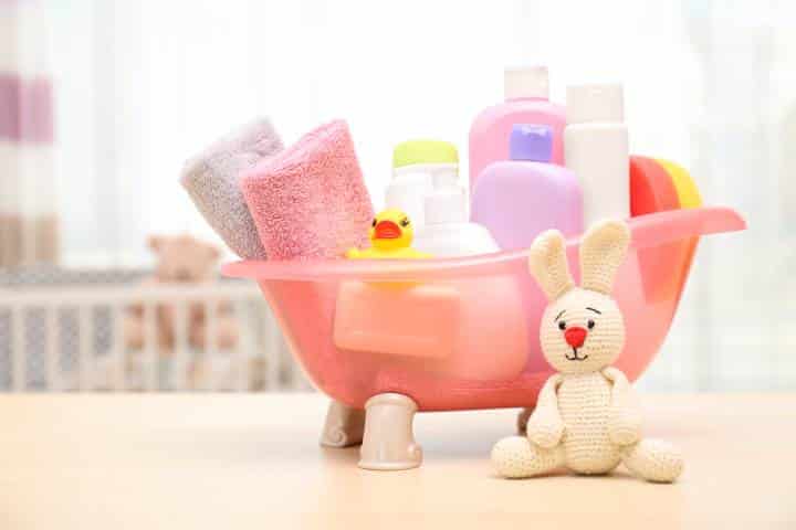 Baby products, toys and towels in a tub basket