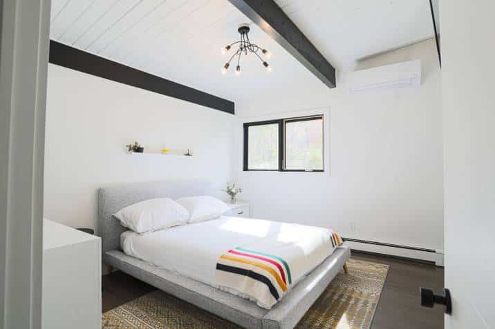 modern bedroom with exposed beams