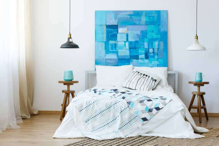 Blue abstract painting on the wall in bedroom