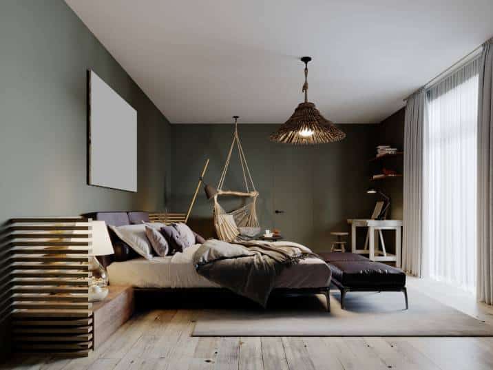 Boho style bedroom interior with olive colour walls and two leather ottomans