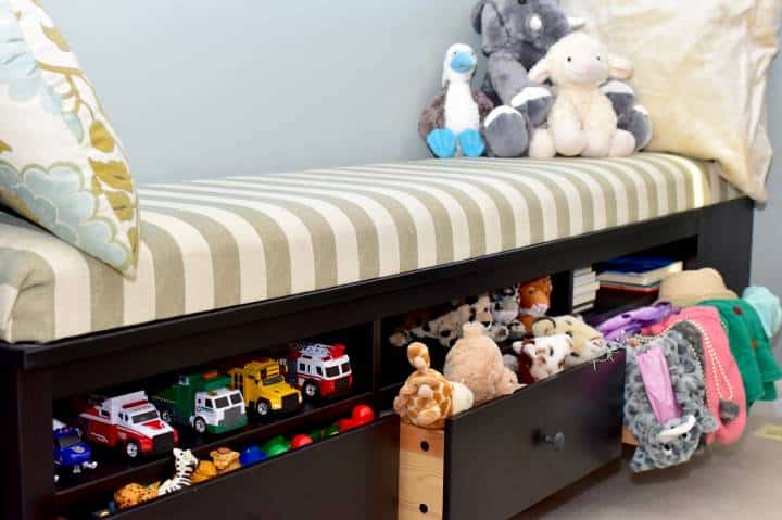 Toddler toy storage solutions in window bench in living room