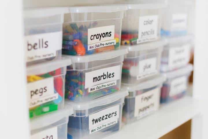 Transparent containers with craft supplies in kindergarten