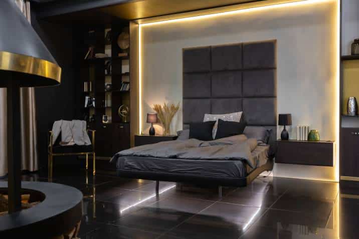 dark modern stylish male apartment interior with lighting, decorative walls, fireplace, dressing area and huge window