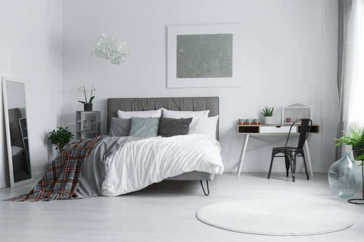 modern grey bedroom, white round carpet lying on the floor