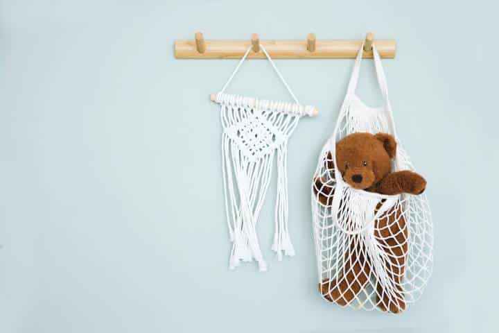 teddy bear inside a hanging macramé
