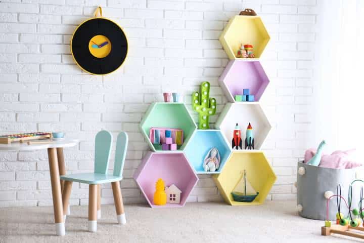 Child room interior with colorful shelves near brick wall