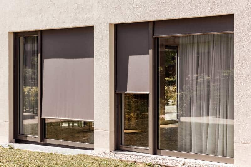 black external roller blinds on panoramic windows