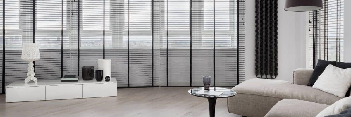 panorama of elegant living room with black window blinds, and stylish white sideboard with decorations