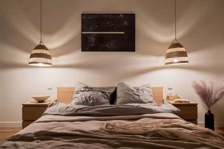 cosy and elegant bedroom rattan pendant lamps with warm light, big bed, nice bedclothes, wooden bedside tables