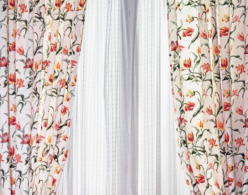 double-layer curtains in fabric with floral pattern and white tulle