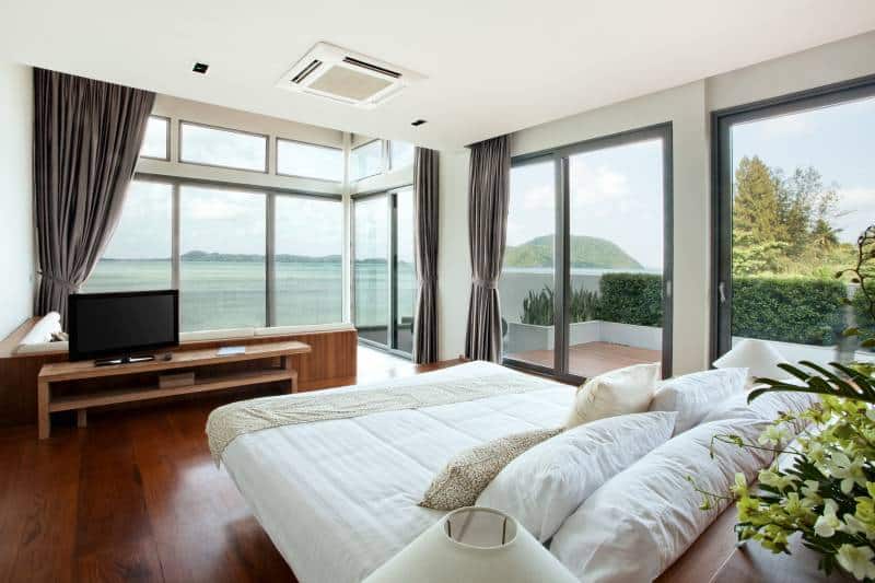 thick blackout curtains, panoramic view of nice cozy bedroom with beach view