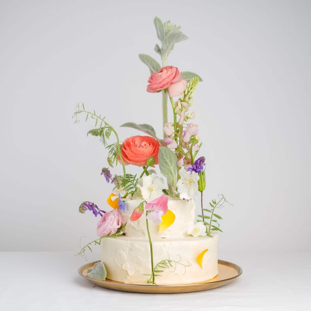 wedding cake with towering florals