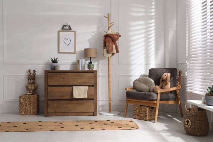 Stylish room interior with wooden chest of drawers