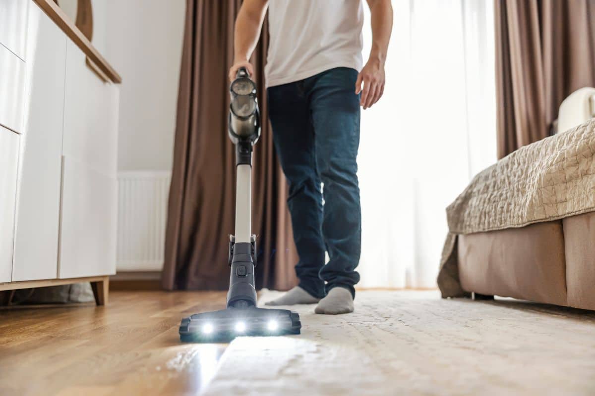 Cropped picture of a man vacuuming at mother’s home and doing chores, acts of service on Mother’s Day