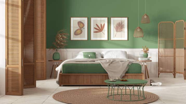 Wooden country bedroom in white and green tones. Mater bed with blanket. Wooden panel and parquet floor, carpet and table, breakfast with cookies
