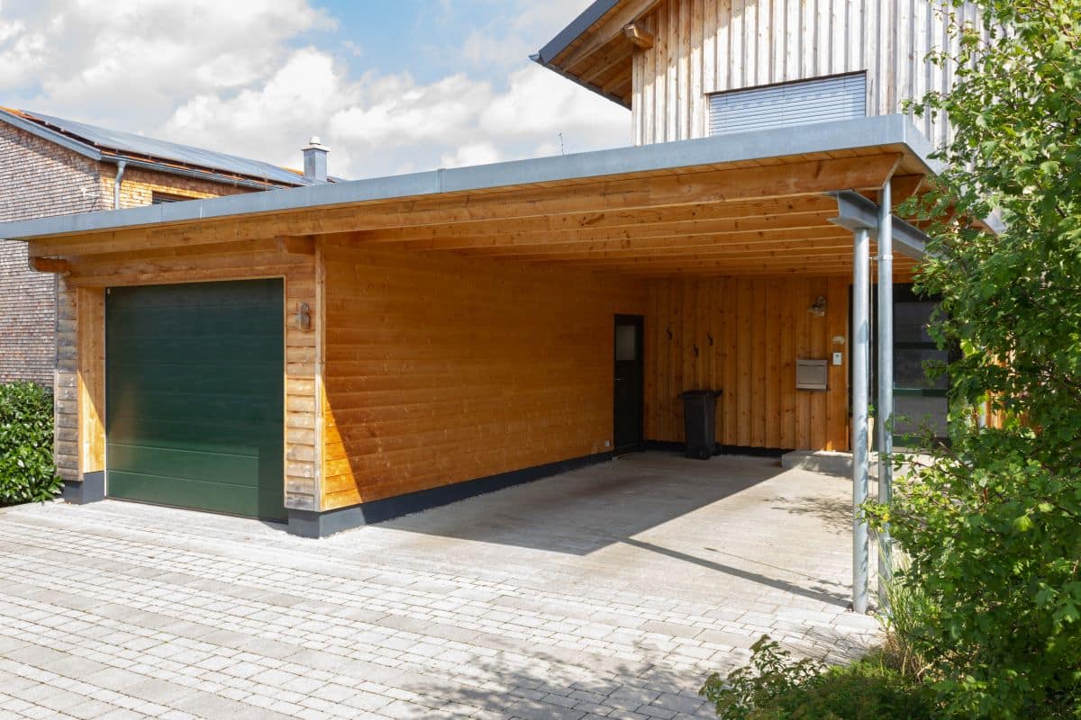 wooden and modern carport with enclosed garage on the side 