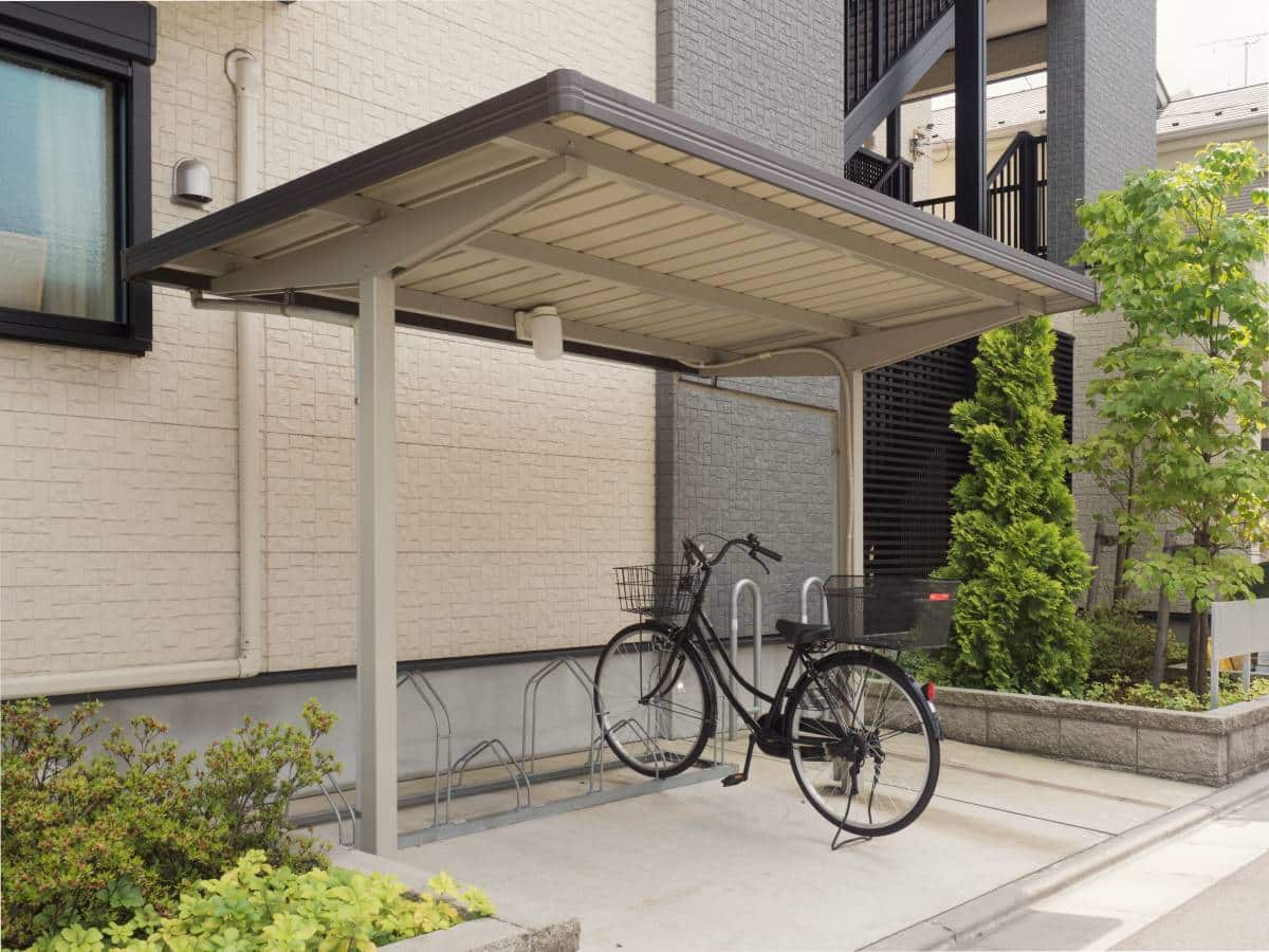 Residential carport with bike rack. A bike is parked on the rack