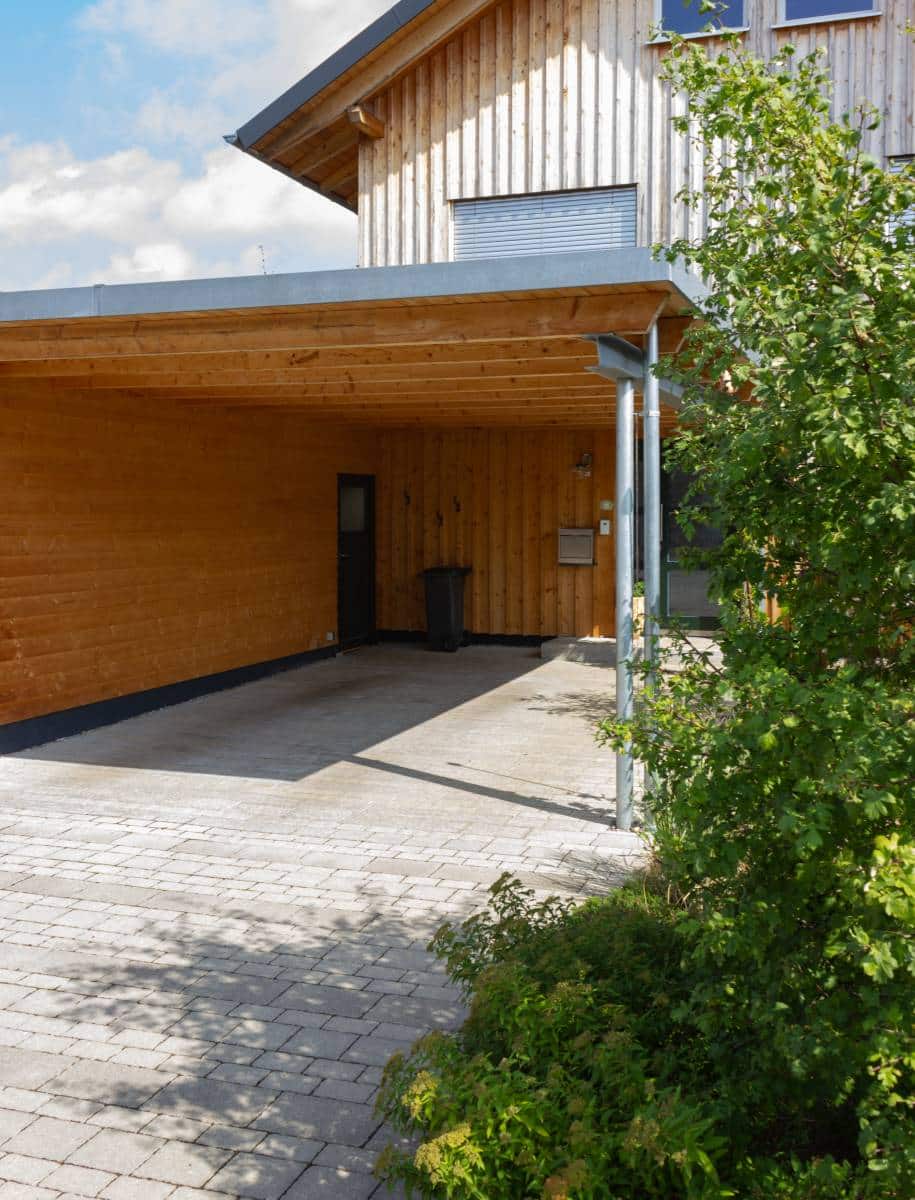 wooden, flat-roof carport with concrete floor tiling