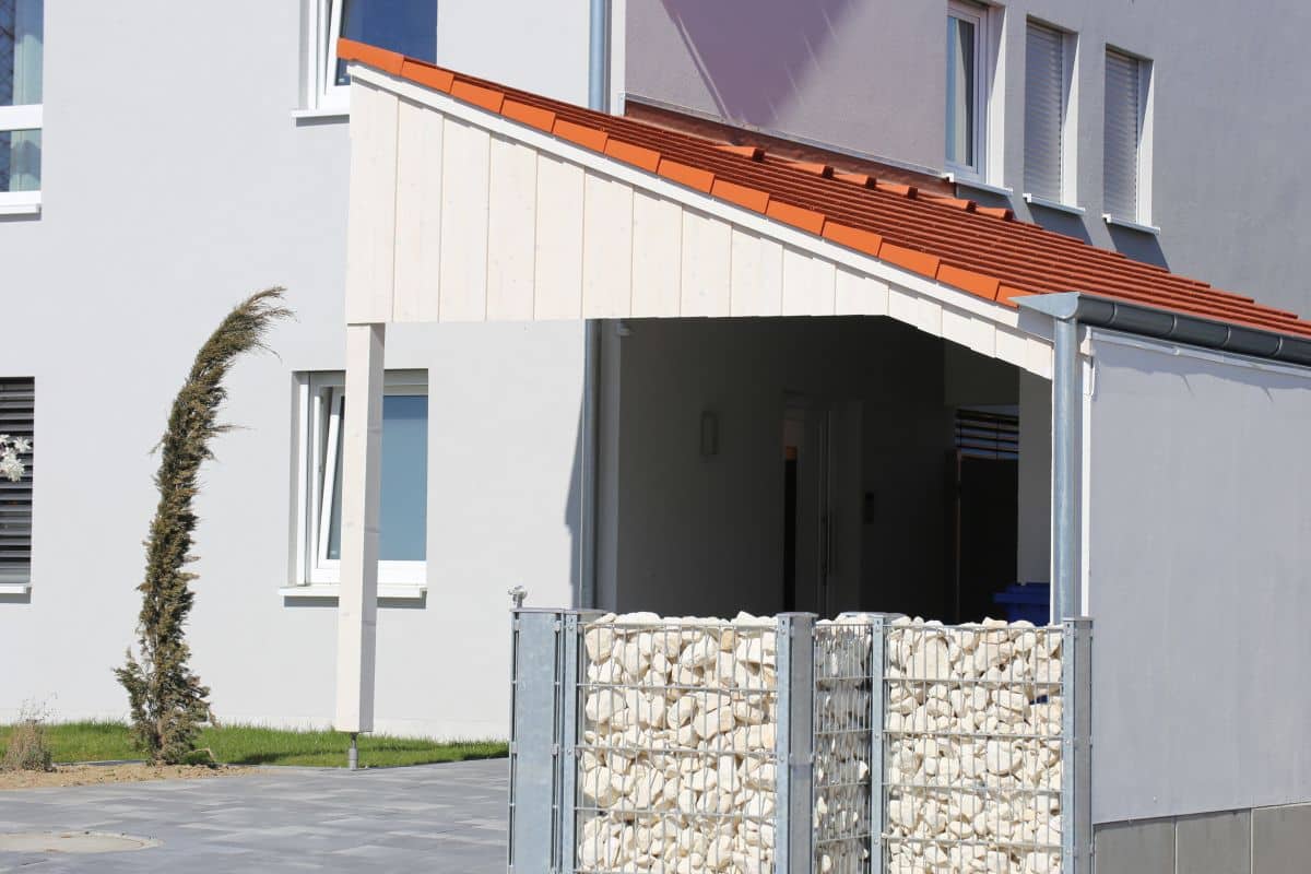 carport with skillion roof on the side of a house 
