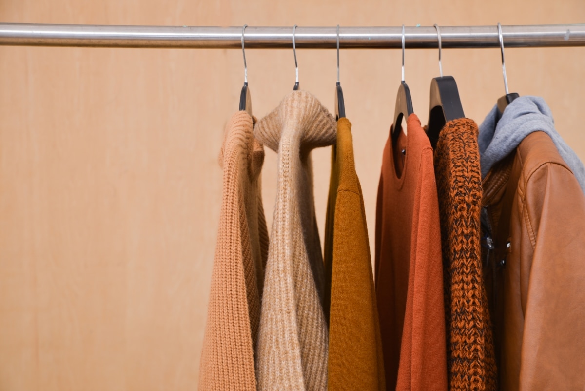 Set of fall-themed clothing hanging on a rack