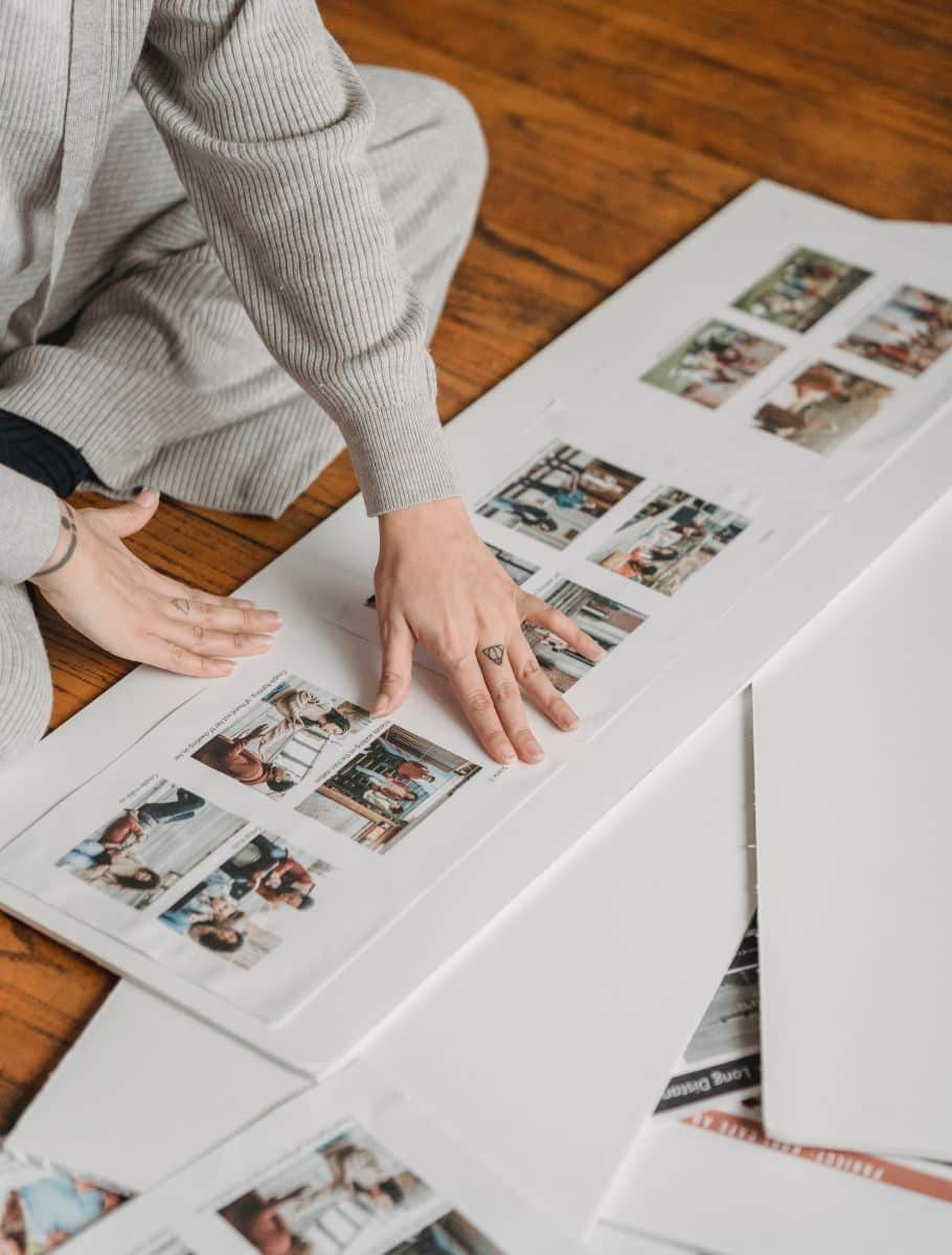 Crop person gluing family photos to poster