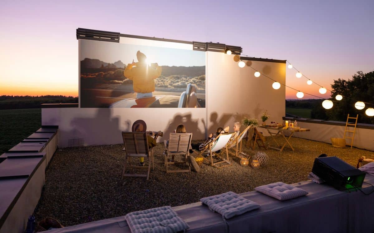 Family watching movie from projector on the rooftop terrace at sunset, Ways to spend quality time with family on Mother’s Day 