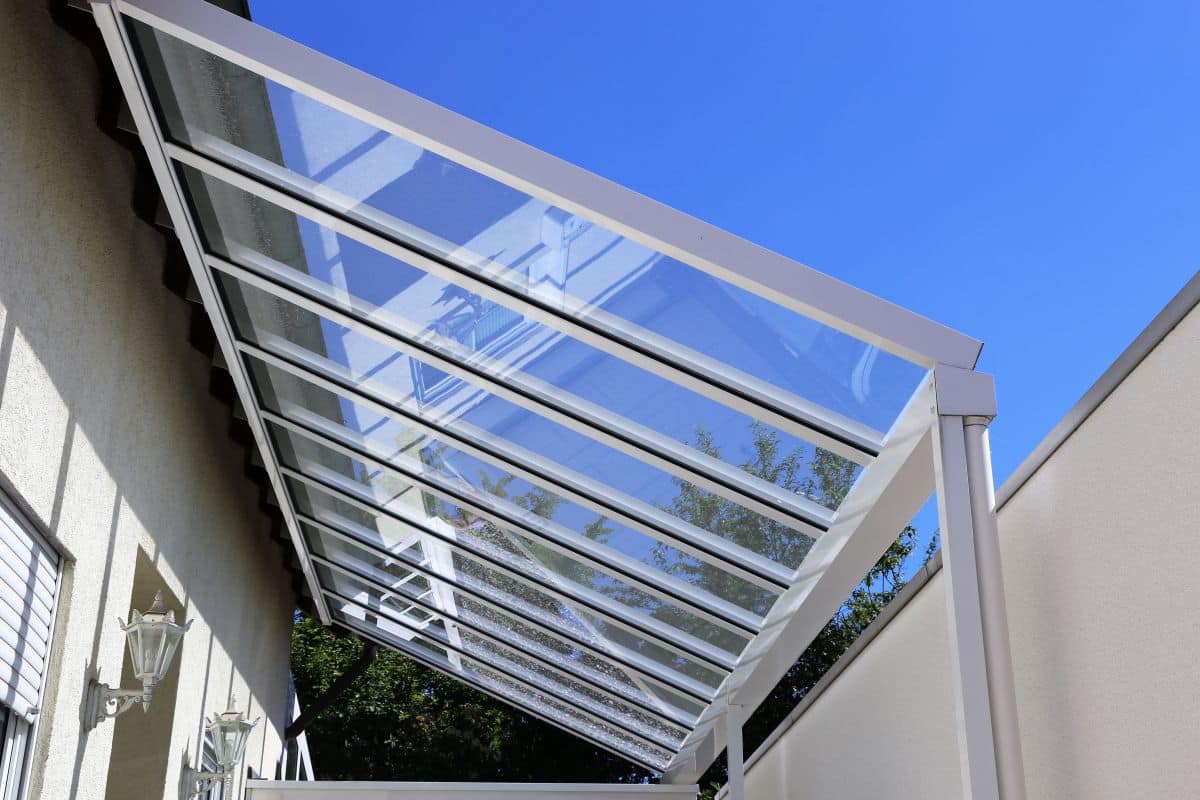 carport canopy with glass panel roof, view from below looking towards the sky