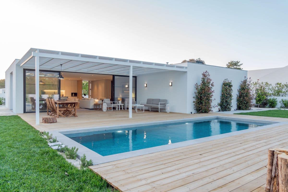 Modern villa with pool deck and indoor-outdoor lounge