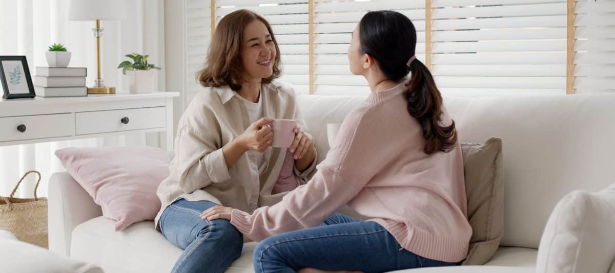 Things to do on Mother’s Day, Mother and grown up daughter talking and spending quality time on couch