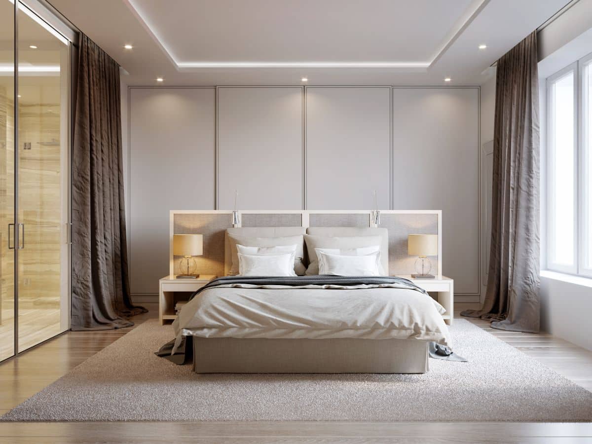 modern bedroom with simple recessed lights, white walls, soft beige curtains, white furniture