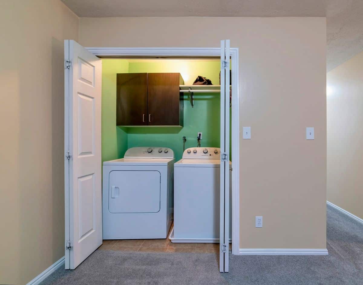 Sliding closet door opened up, showing a small laundry room 