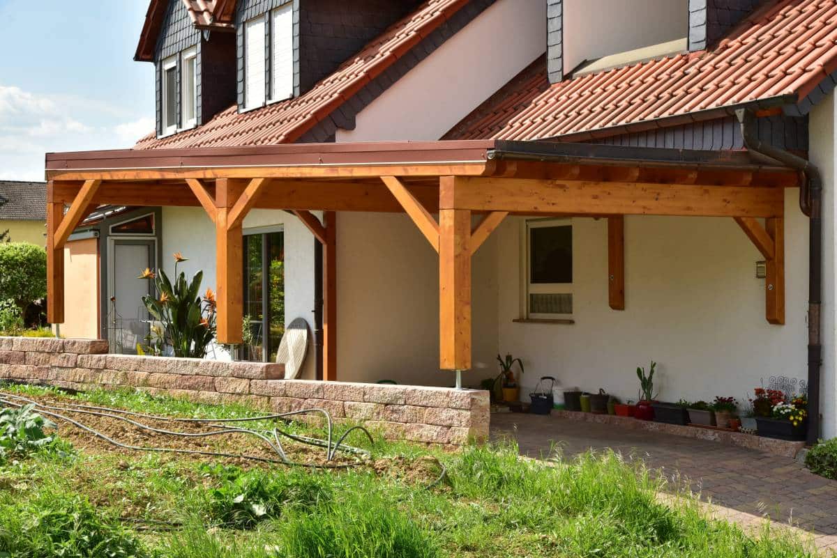 wooden wall-mounted carport with rain gutter and rainwater pipe