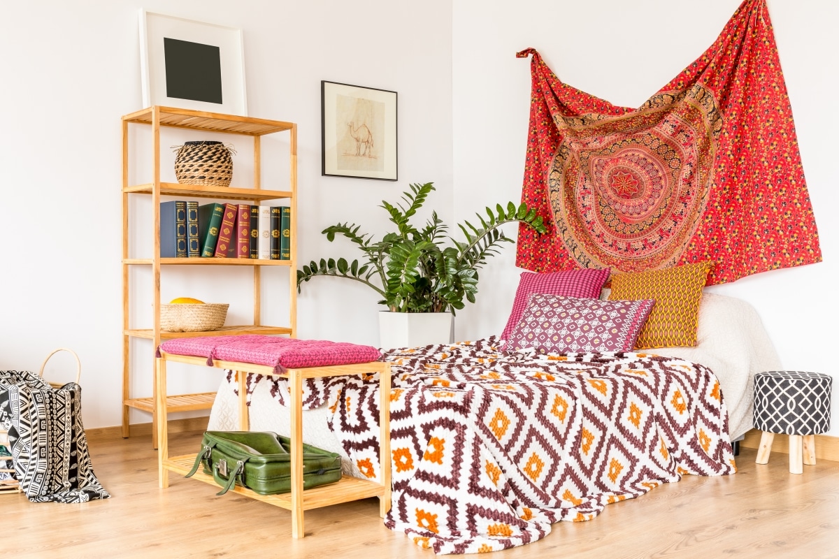 vibrant patterned sheets and tapestry in bedroom