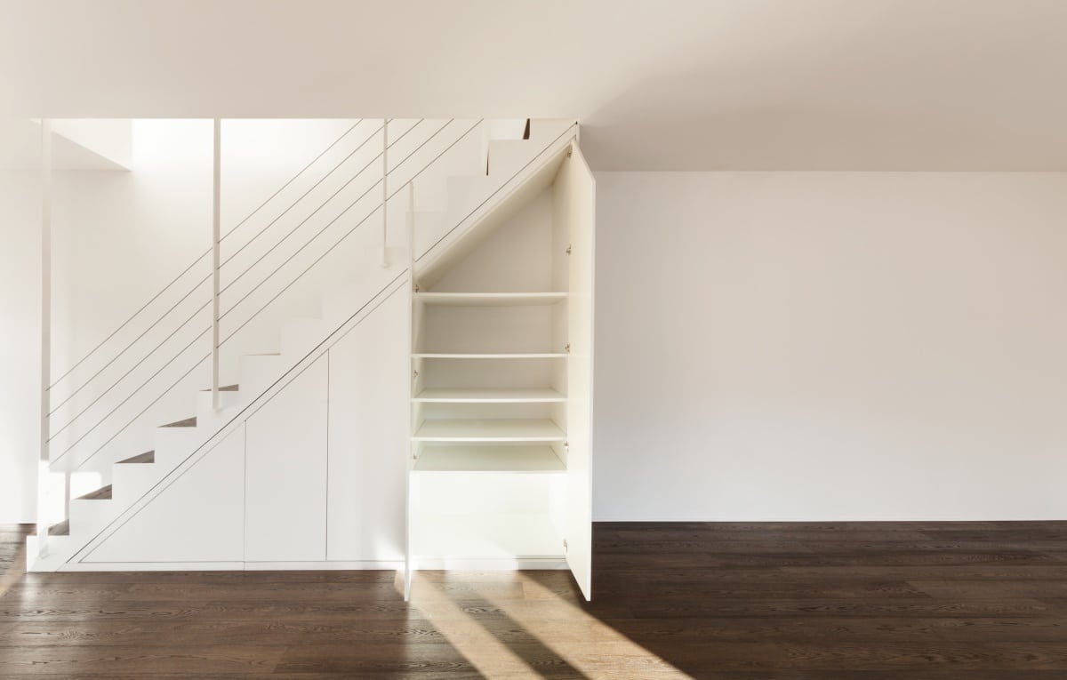 empty home interior with shelf under stairs
