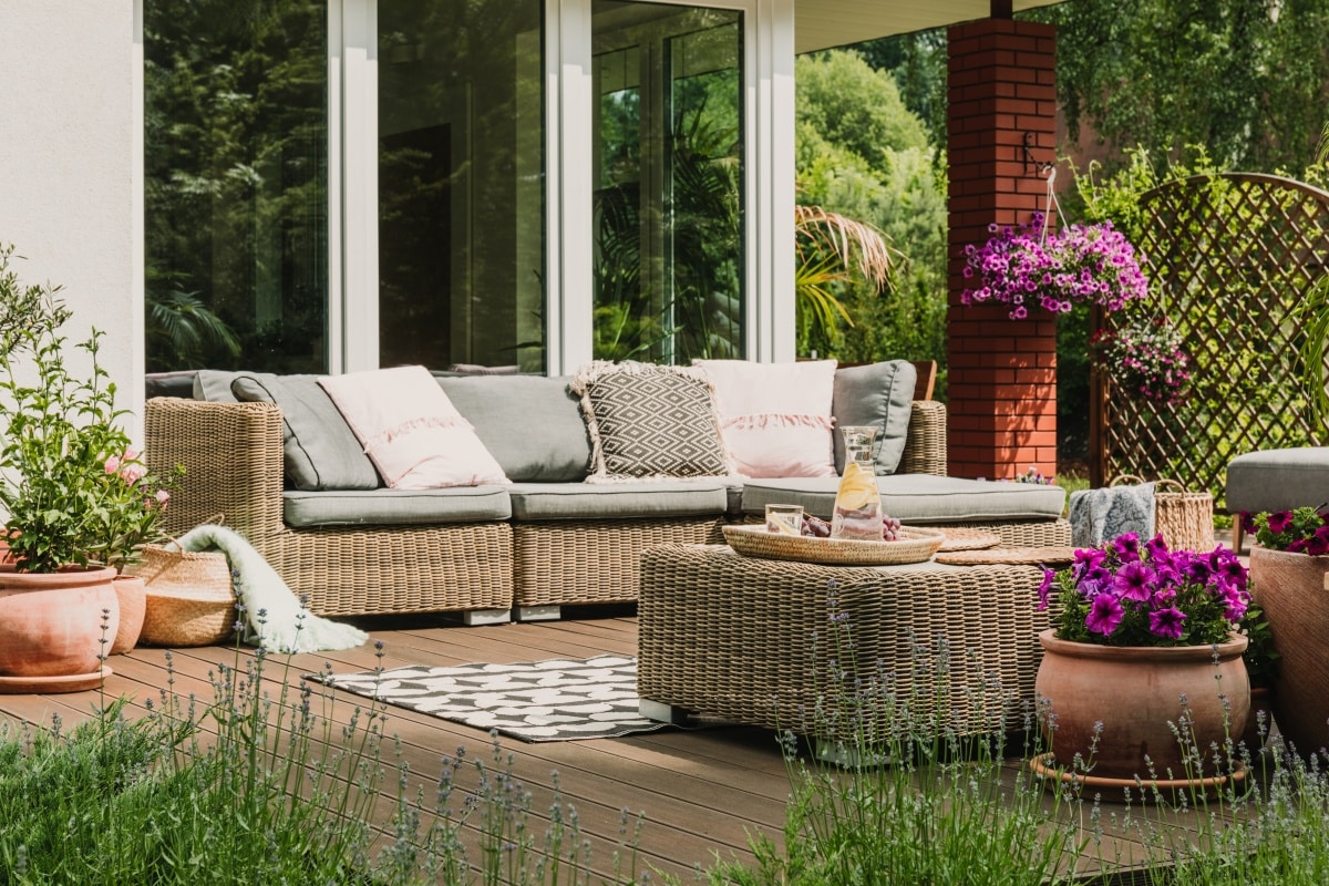 Classy furniture on wooden terrace in garden