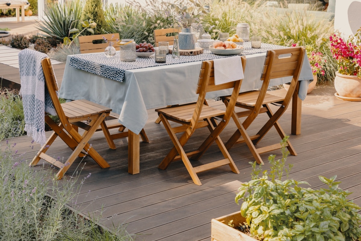 dining table with wooden chairs set on the terrace