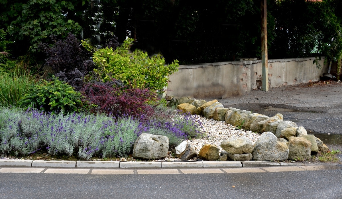 sandstone walls and stones in a flowerbed in a terraced terrain