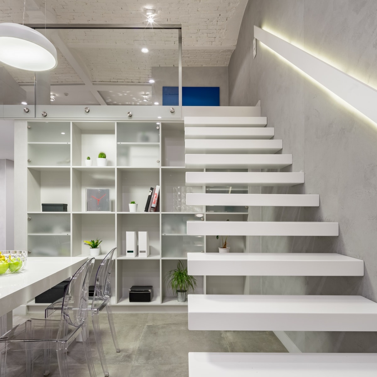 Loft apartment with white, modern, mezzanine stairs with led light in railing