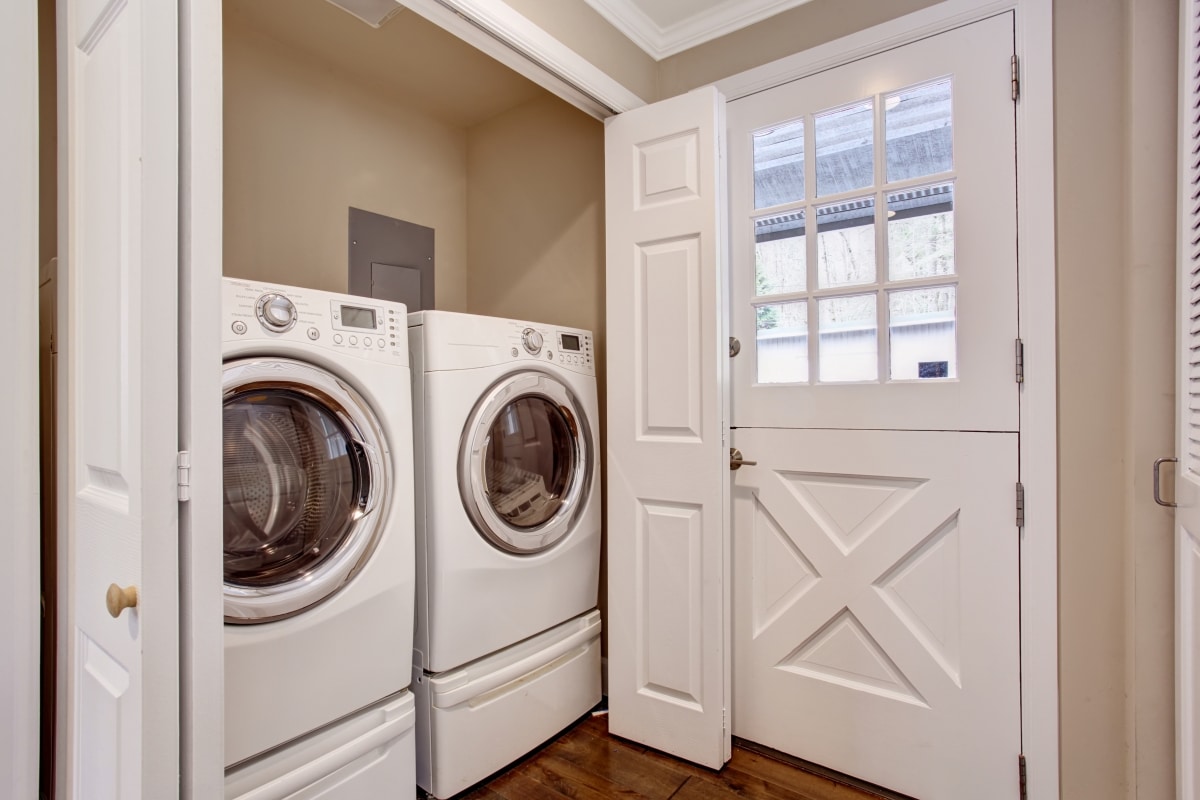 hidden laundry room with washer and dryer