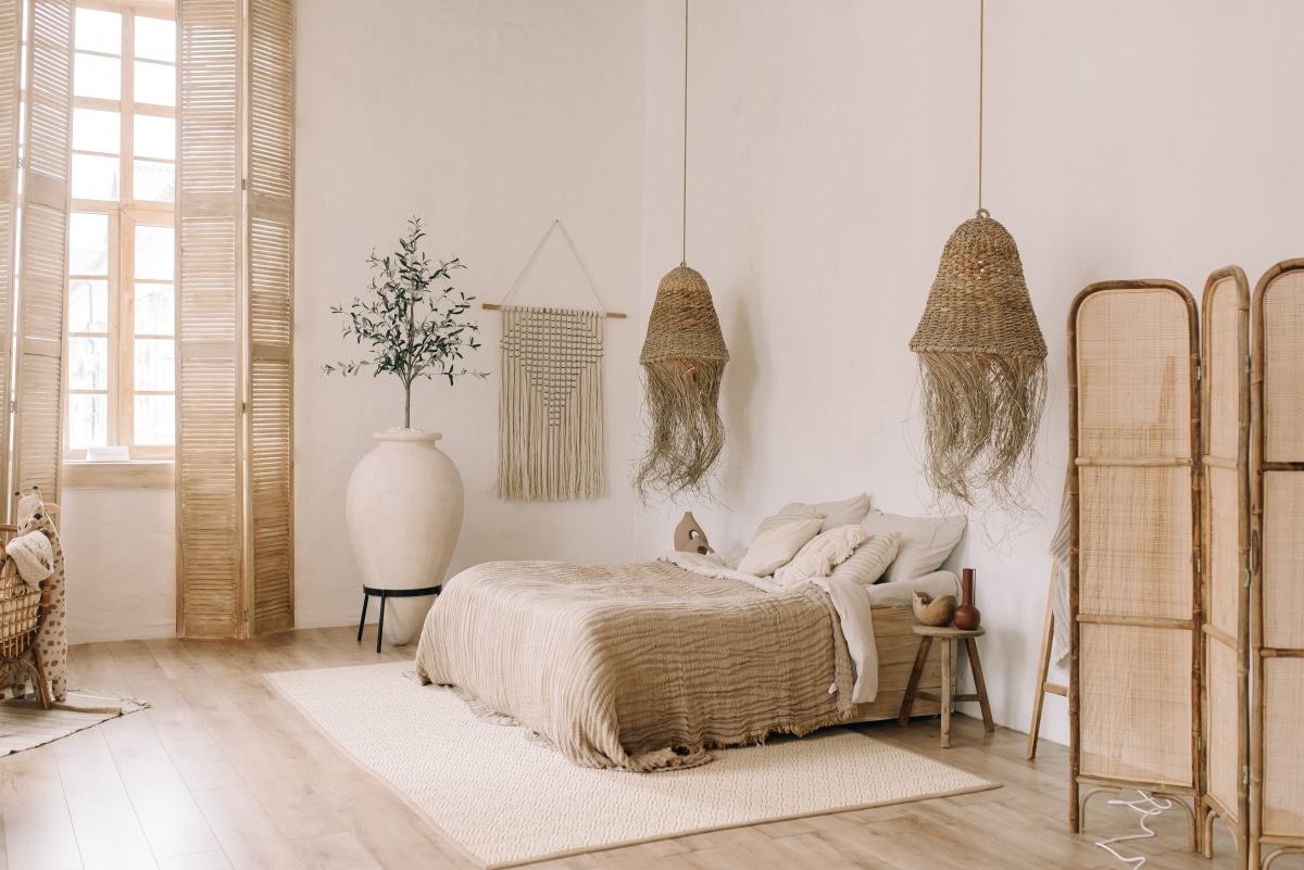 woven chandeliers and divider in boho bedroom