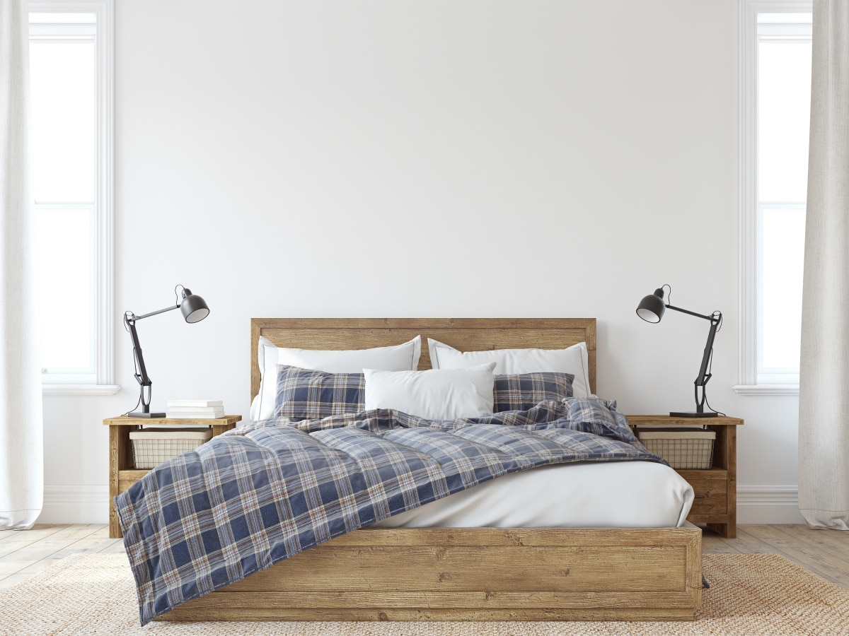 Bedroom with wooden side tables on each side of a bed with plaid bedding