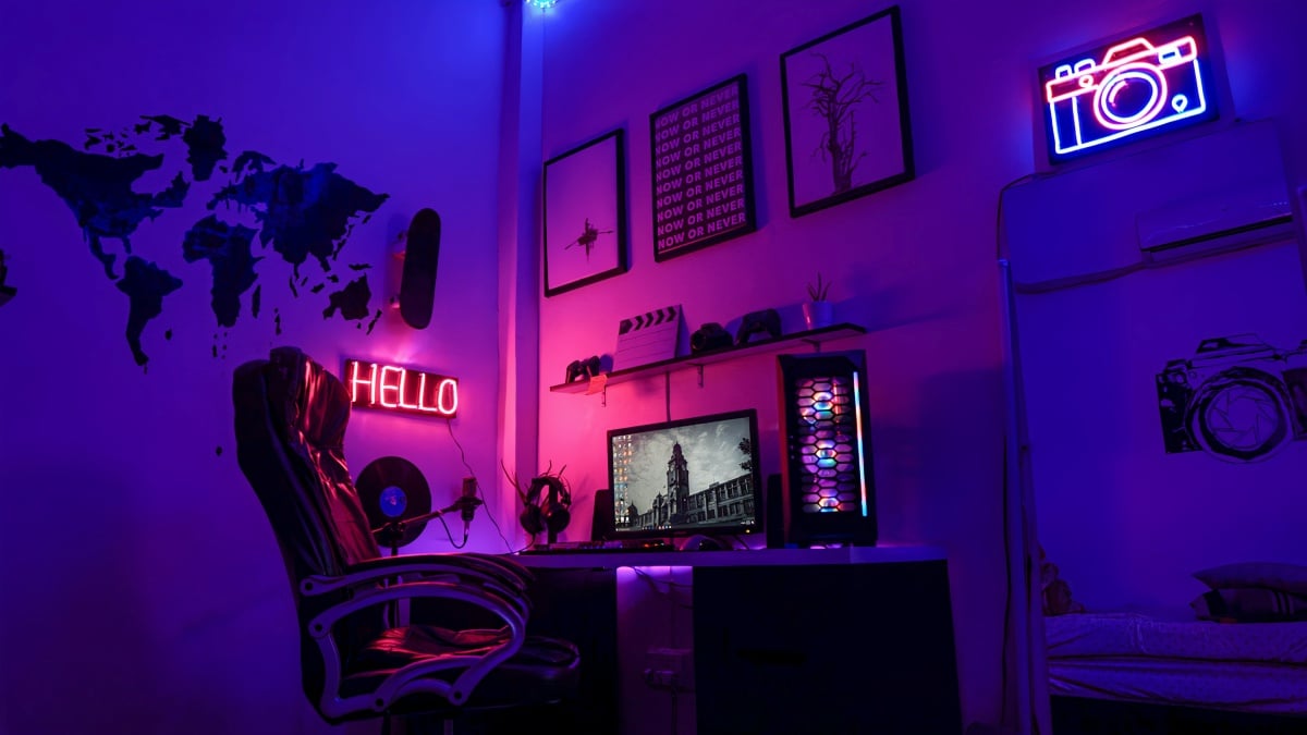 Computer in dark room, lit by neon ligths