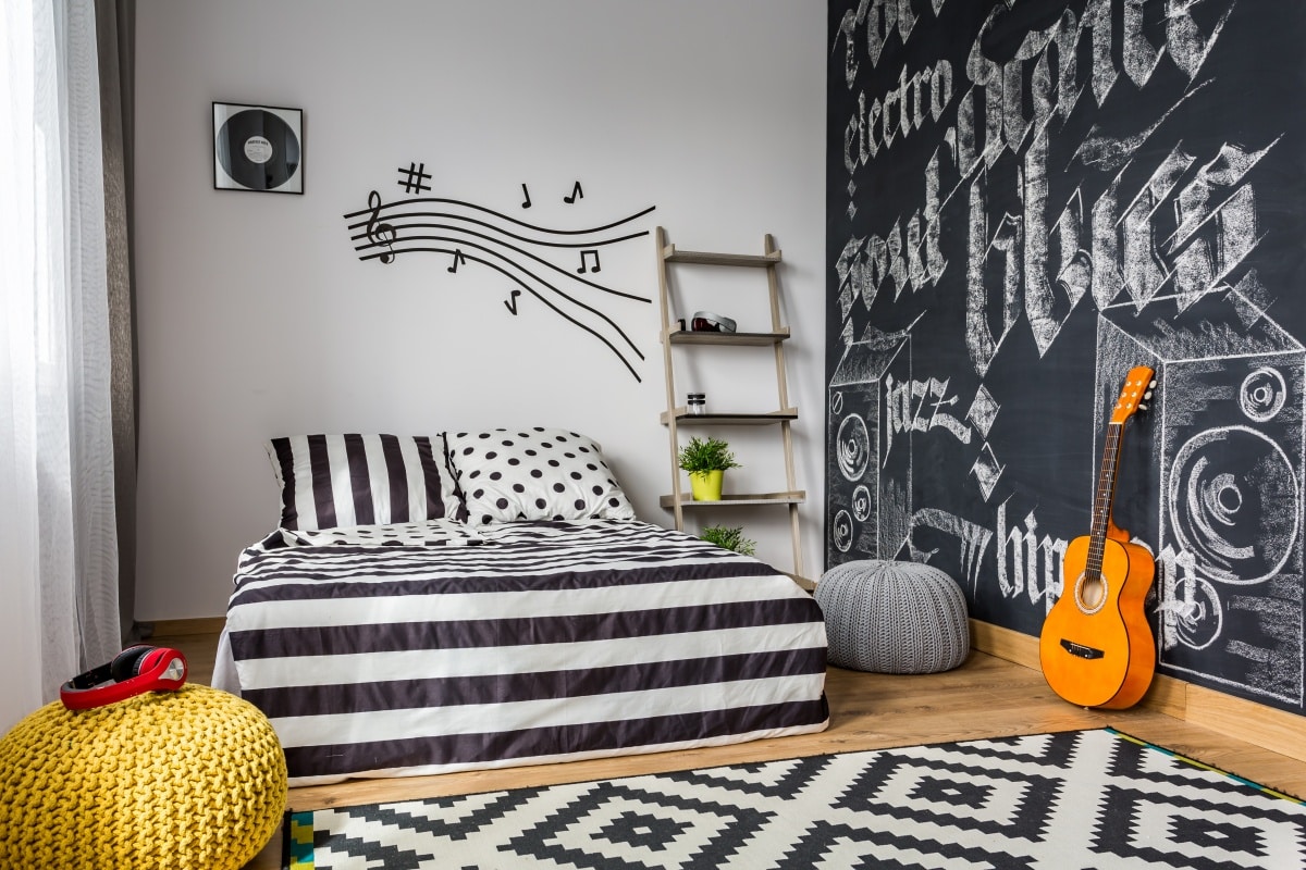 Monochrome bedroom interior with music decals and music-inspired wall mural