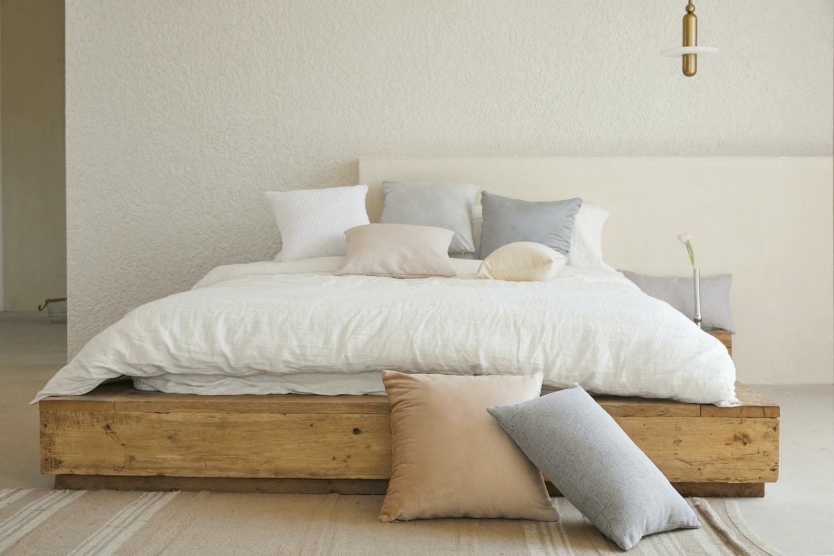 Simple wooden bedframe in minimalist bedroom