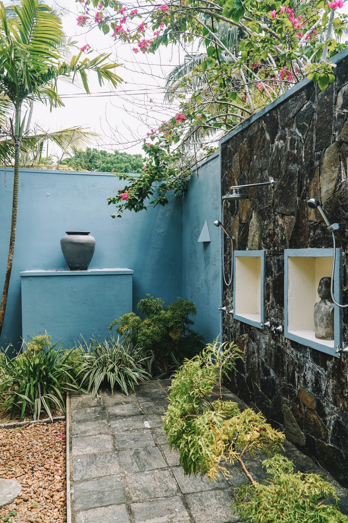 Outdoor shower on the wall of a garden