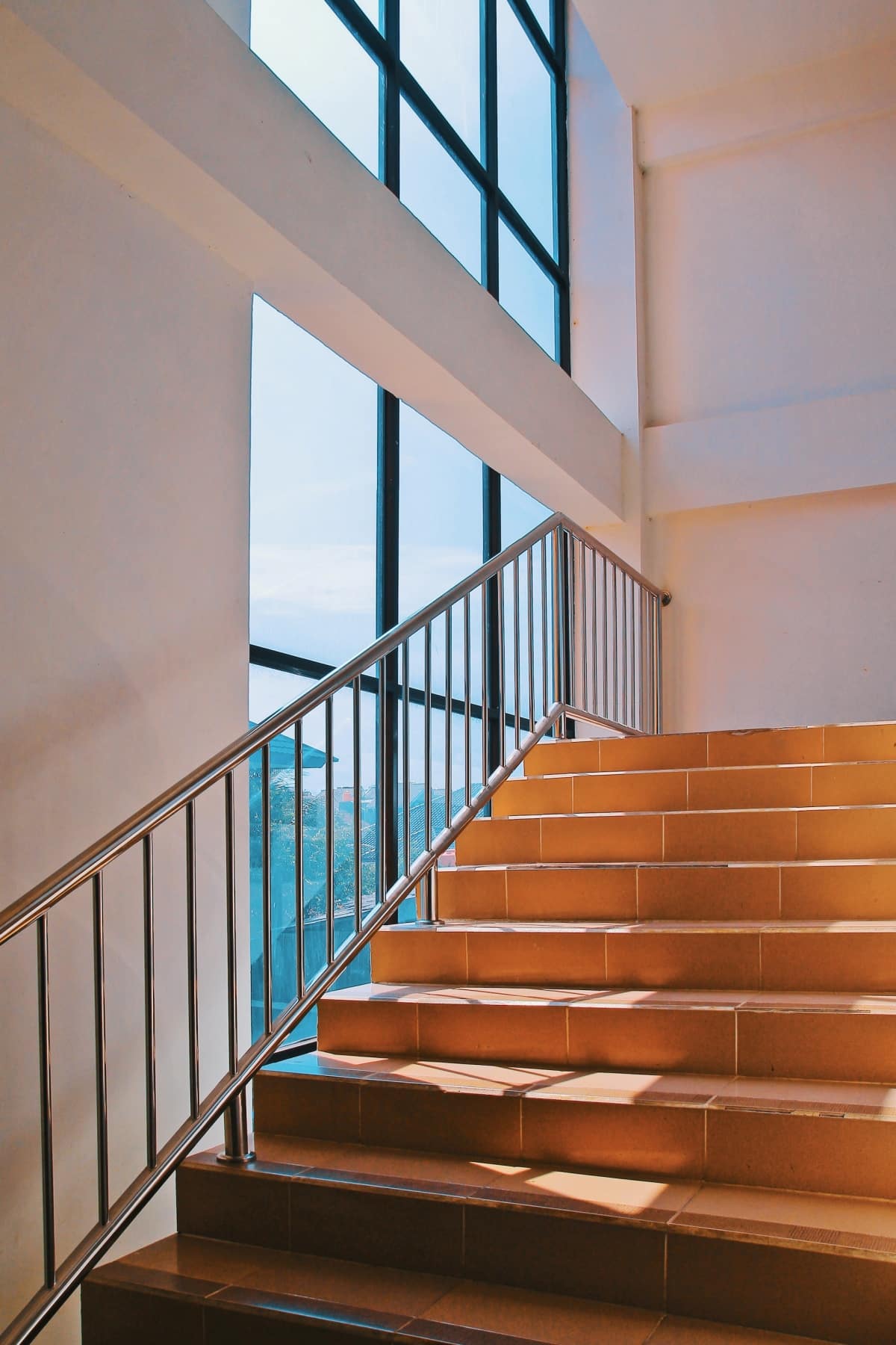 tiled stairs near wide windows