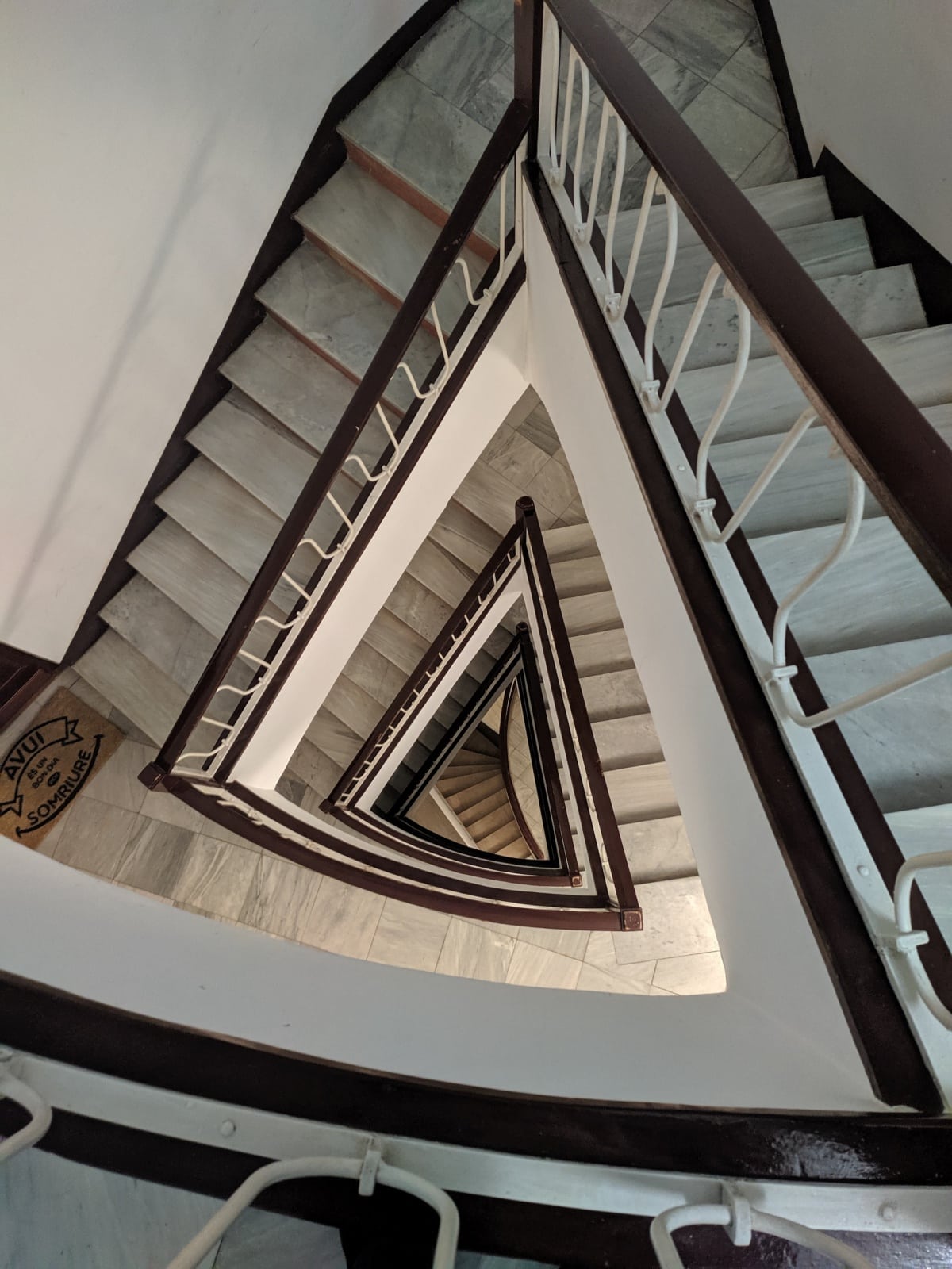 white and brown triangular staircase