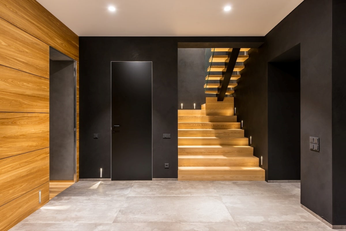 Modern spacious corridor with wooden staircase